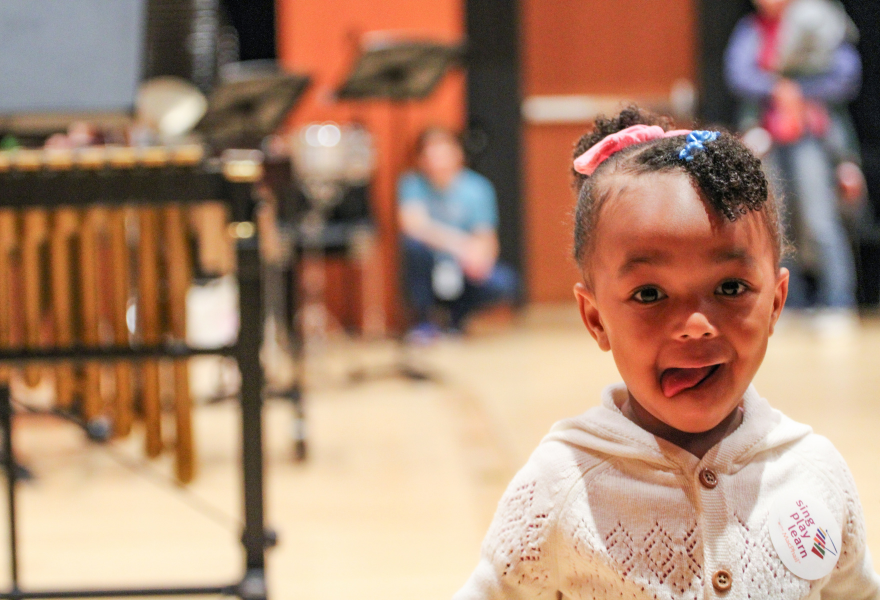 Photo of a young child exploring instruments at MacPhail.