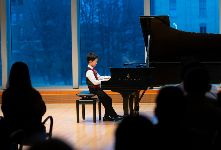 A young MacPhail student plays piano during the Student Performance Festival 2025.