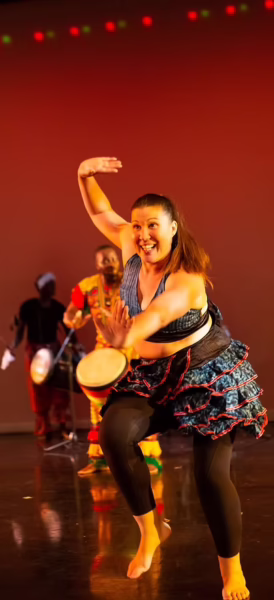 Photo of Whitney McClusky dancing on stage.