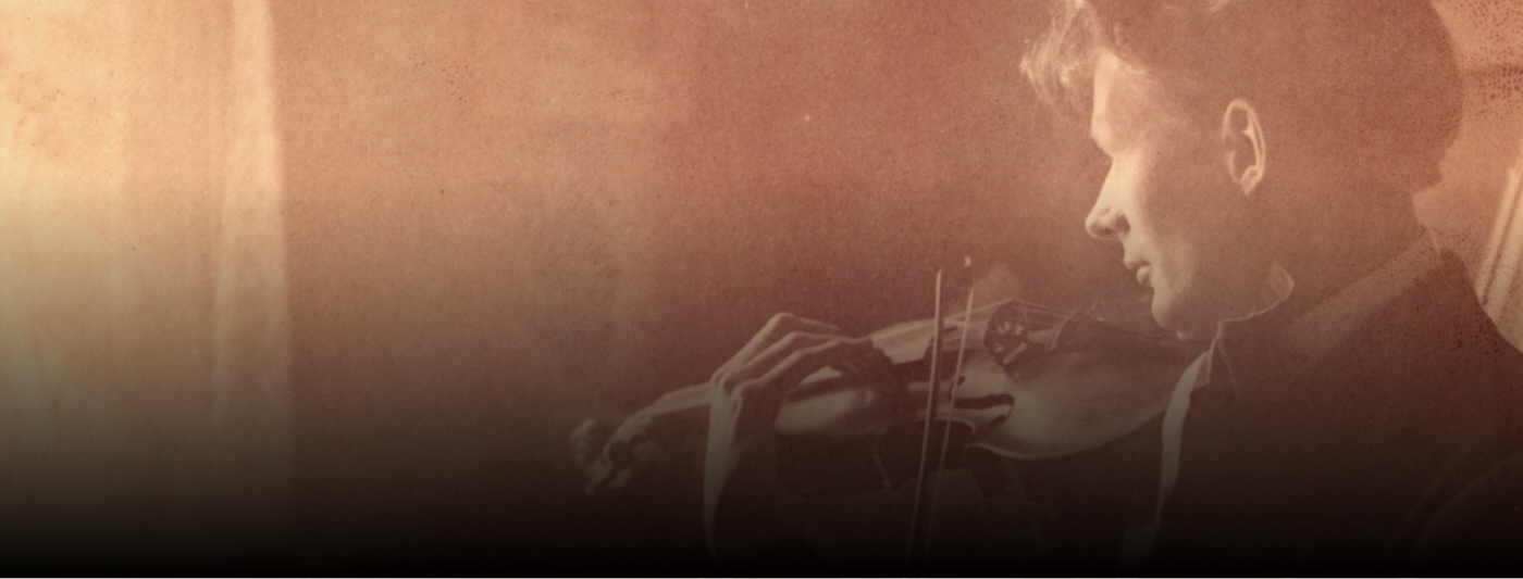 Old photo of a person playing violin