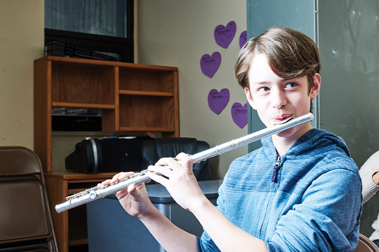Young student playing flute