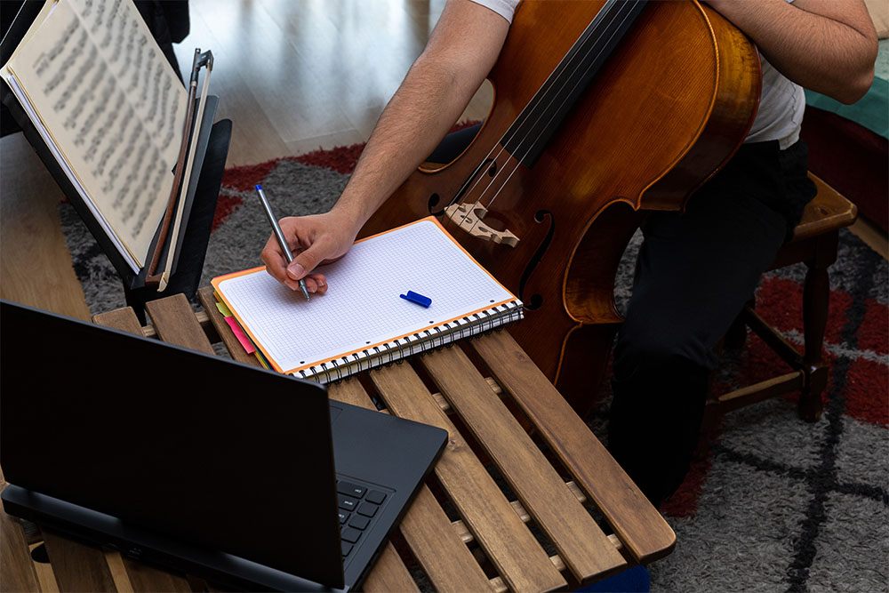 Musician with cello and computer